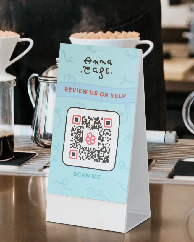 Cafe tabletop display card with a qr code on it.