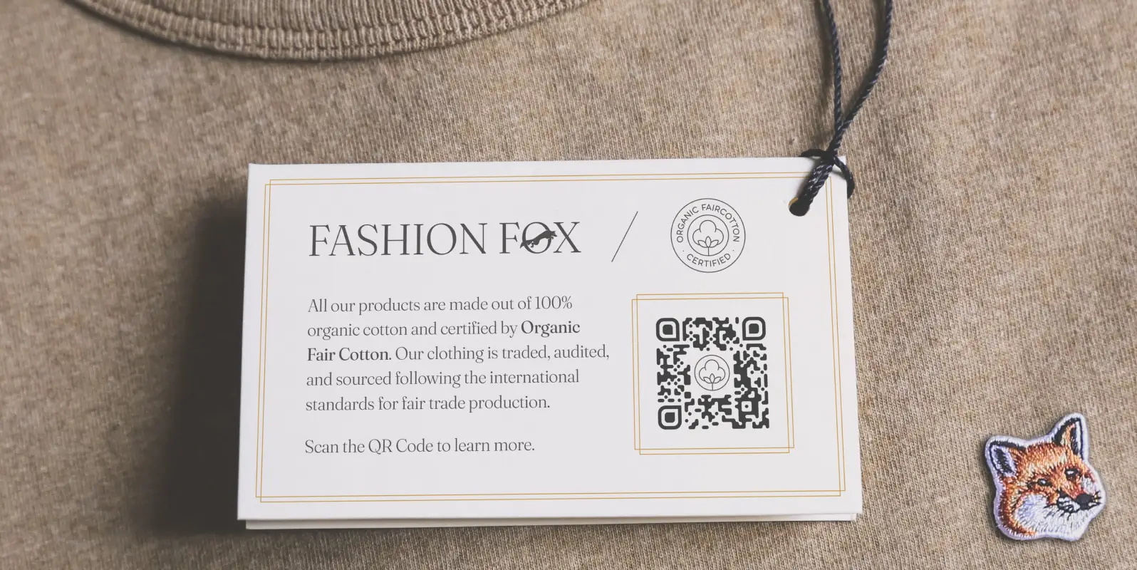 A clothing label tag that describes the sources and materials of the garment. A QR Code can be scanned to learn more.