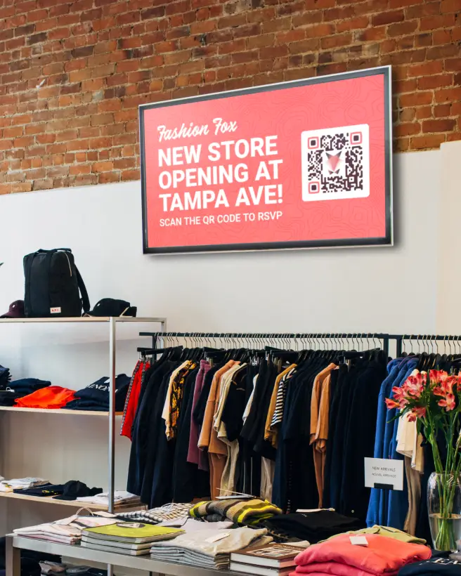 An advertisement on the wall of a clothing store. Customers can scan the QR Code to RSVP for the opening of a new location.
