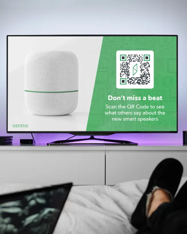 TV showing an add for a smart speaker with the speaker on the left and a big QR Code on the right to scan and read testimonials.