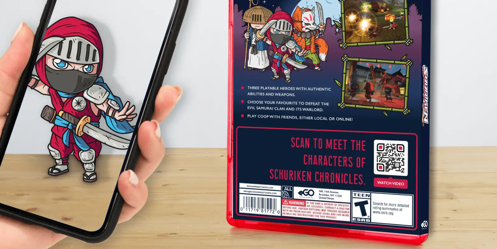 Hand holding a smartphone displaying a video game character and the back of a video game box showing scenes from the game and characters and with a QR Code on it.