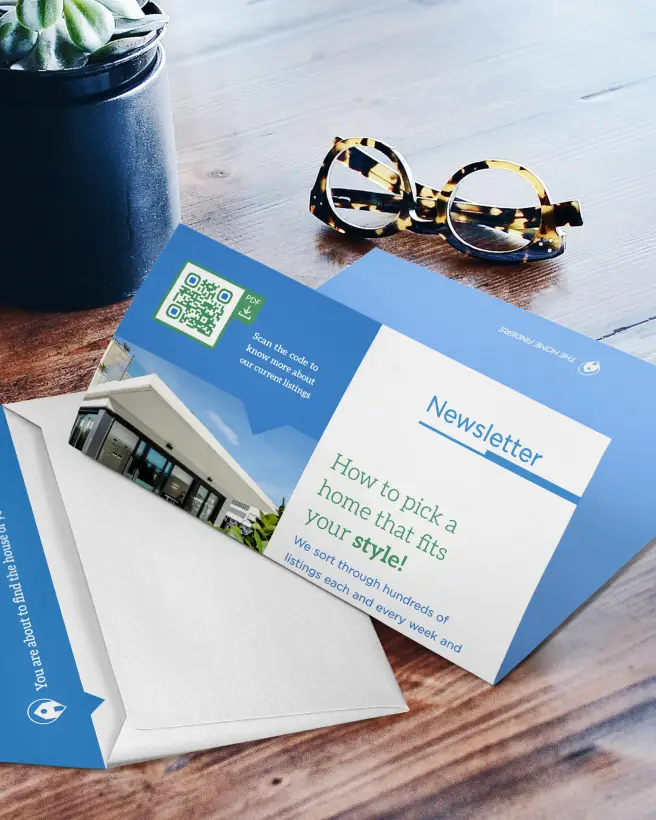 A real estate newsletter laying on a table. It features a QR Code with more information on listings.