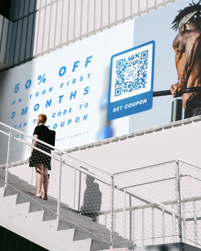 A large banner advertisement for a discount coupon for a gym membership, accessed via QR Code.