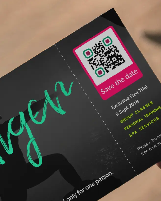 A ticket stub for a workout class. There is a QR Code in the top right corner that allows users to save the date.
