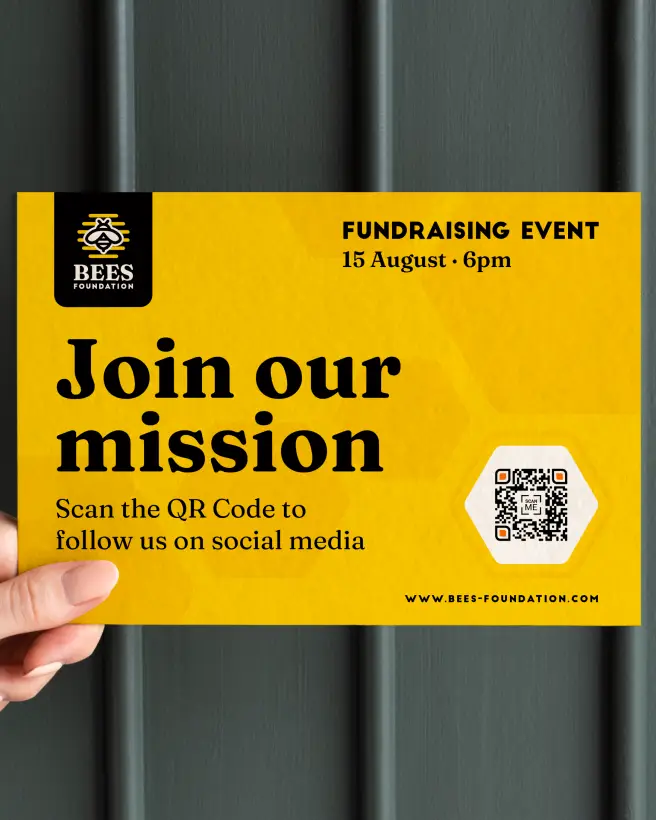 A hand holding a flyer for a fundraising event. A QR Code links to the foundation's social media.