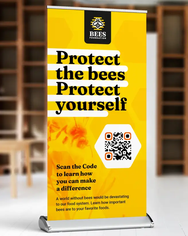 A standing poster encourages readers to scan a QR Code to learn more about how they can help save the bees.