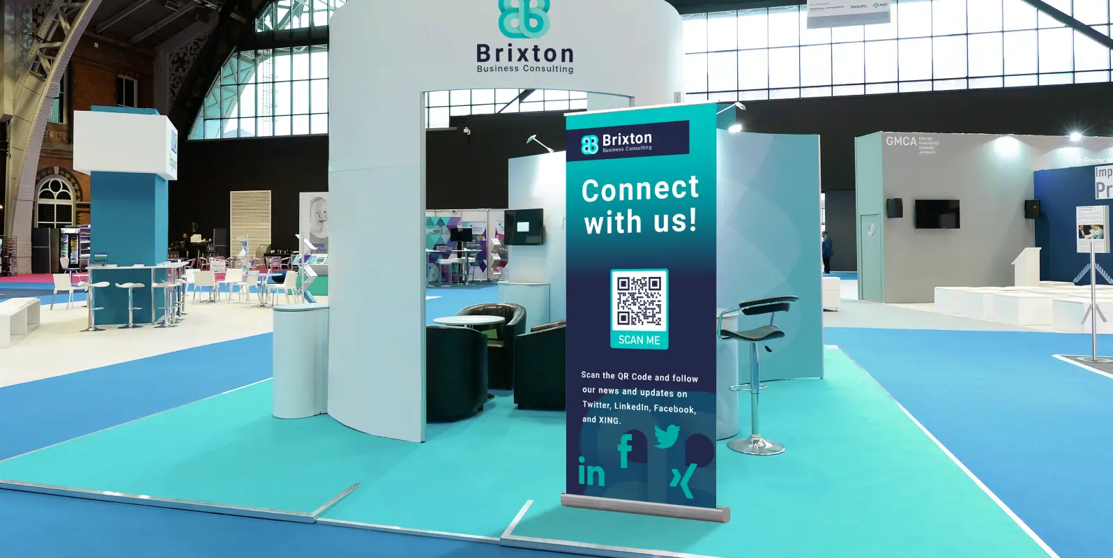 An event booth featuring a poster with a QR Code that allows scanners to follow the company's updates.