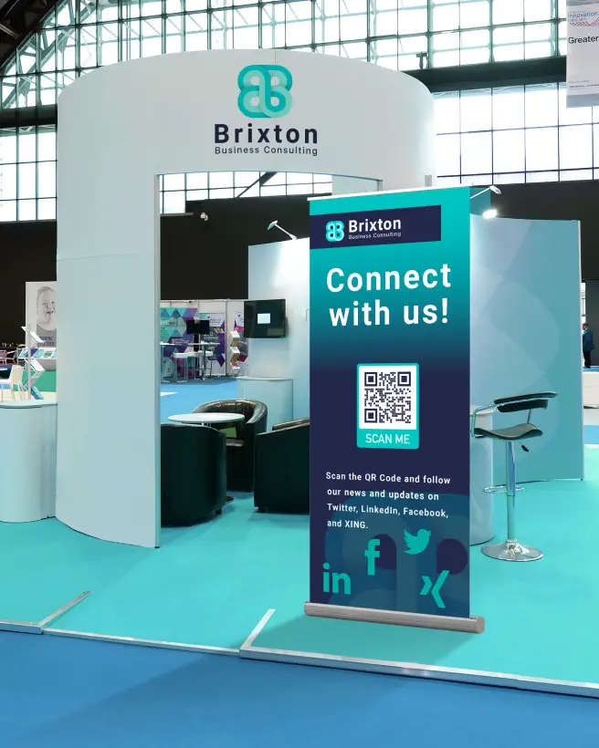 An event booth featuring a poster with a QR Code that allows scanners to follow the company's updates.