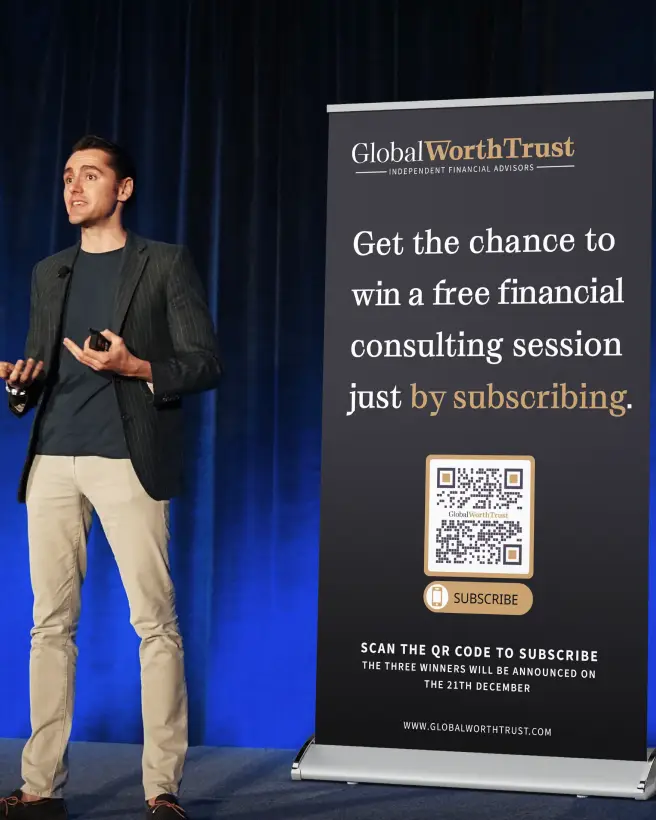Man presenting and standing next to a big banner ad for a finance company with a QR code on it.