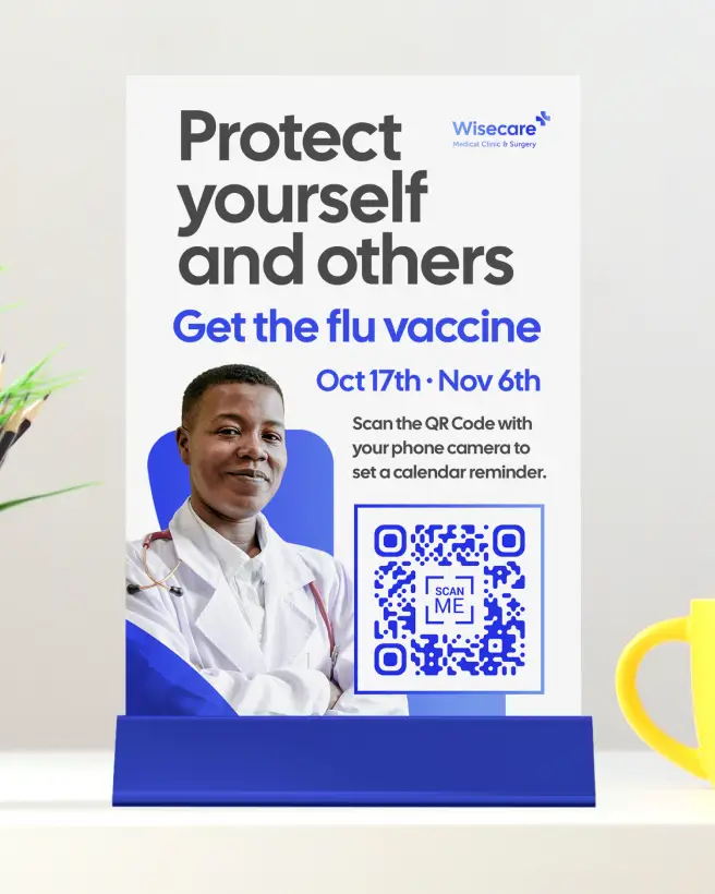 A flower pot with pens and pencils next to a clinic's tabletop sign promoting a flu vaccination. There's a QR Code on the sign for setting a calendar reminder.