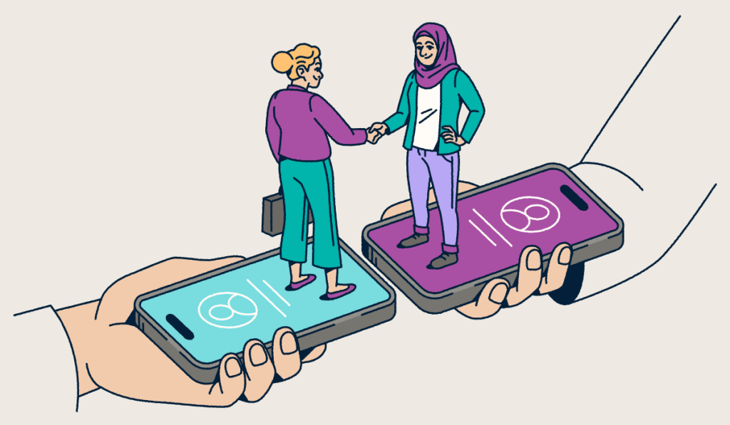 Two people standing on smartphones shaking hands.