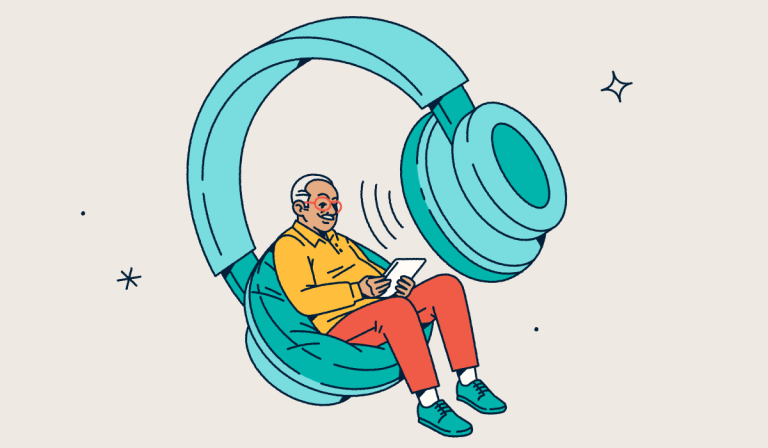 A person looking at a tablet while sitting in one side of a giant pair of headphones.