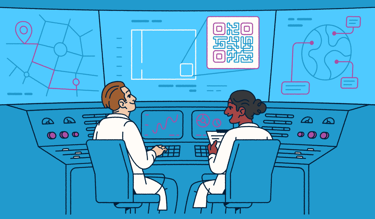 Two scientists sitting at a console looking at screens with QR Codes and graphs.