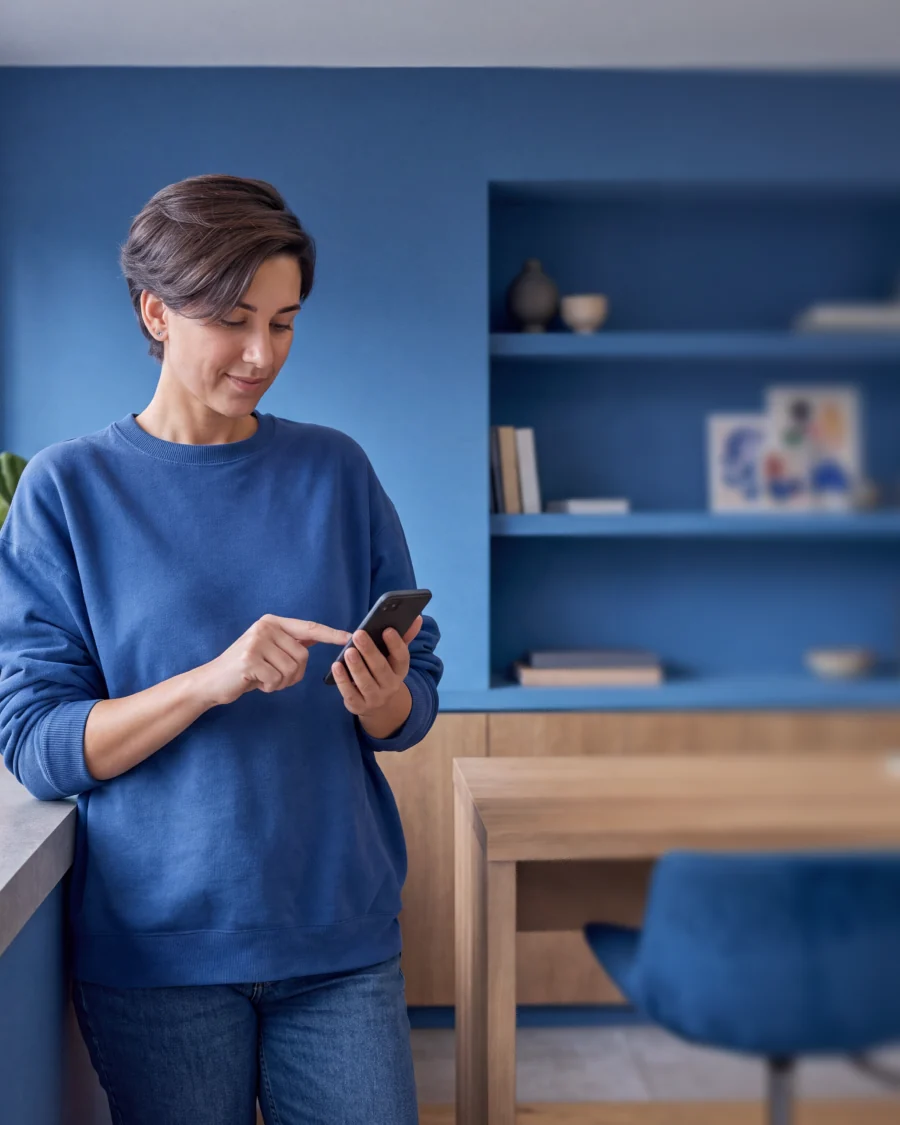 A woman reading a delivery message with a tracking link on her phone
